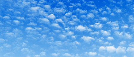 Field of Alto-cumulus clouds on blue skycinematic ratio background