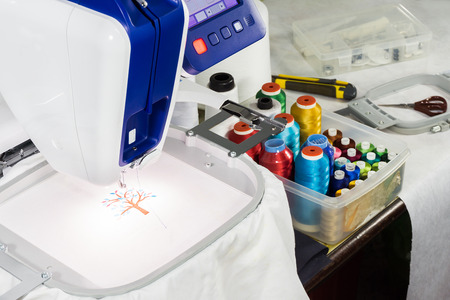 workspace of the embroidery machine and tool on the tableの写真素材