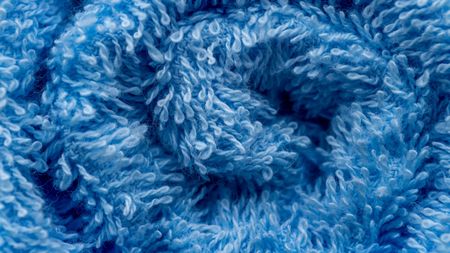 Macro picture of surface blue towel texture background spiral lineの写真素材