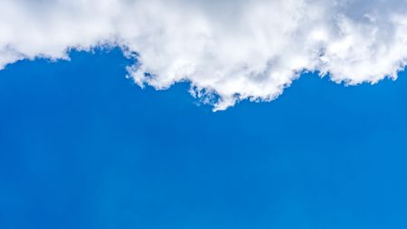 Clear sky and fluffy cloud  blue background