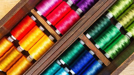 Spool of sewing threads  in the old wooden box, close up, top view pictureの写真素材