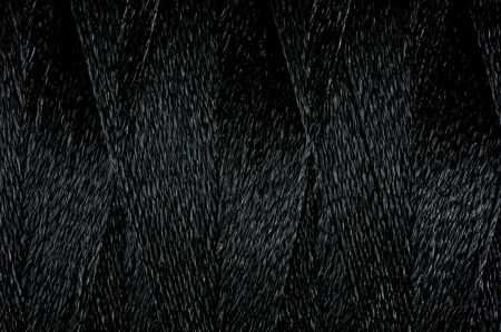 Macro picture of sewing thread texture black color