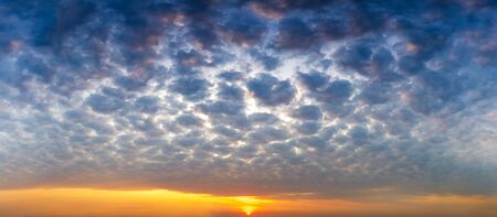 Panorama messy sky with altocumulus cloud and sun, nature sunrise or sunset scenic backgroundの写真素材