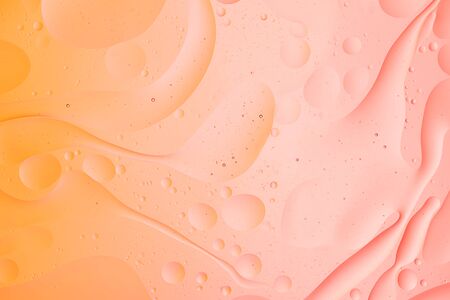 abstract macro background of oil fluid on water image orange and pink color gradient wallpaperの写真素材