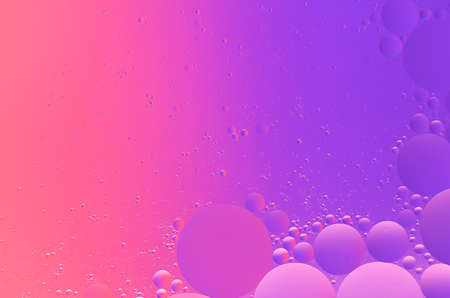 Abstract colorful macro background of oil on water purple and magenta color gradientの写真素材