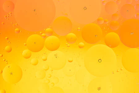 Abstract macro background of oil on water orange and yellow color gradientの写真素材