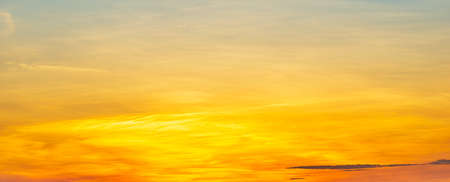 Abstract panoramic golden sky and faded clouds, nature phenomenon backgroundの写真素材