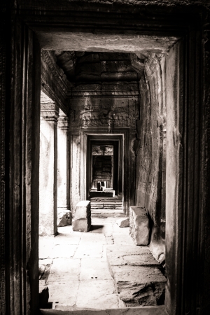 Looking through a passage to a giant face carving in Bayon Temple at Angkor Thom Angkor Wat, Cambodia の写真素材