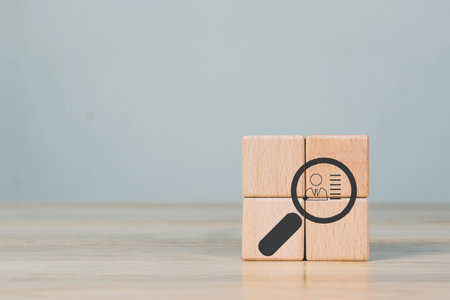 Hand holds wood cubes stacking with person data, Customer psychology profile or characteristics, Buyer personal and target customer concept.の写真素材