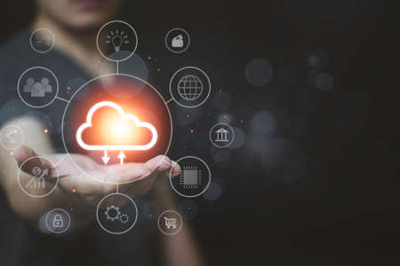 Hand holding to virtual artificial intelligence with cloud computing technology transformation. Cloud technology. Data storage. Networking and internet service concept.の写真素材