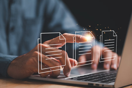Businessman using laptop computer with Virtual screen icons Document Management System (DMS) Online...