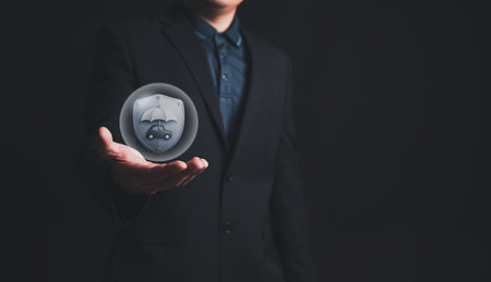 Businessman with protective gesture and car insurance policy iconの写真素材