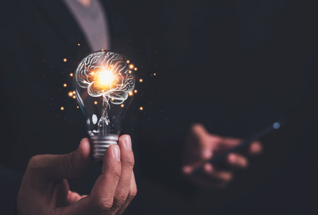 Businessman holding light bulb and brain inside, creativity and inspiration, idea and imagination....
