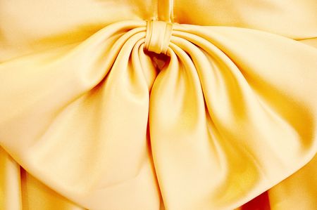 Big bowknot on a yellow silk dressの写真素材