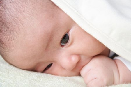 newborn baby covered by blanket.