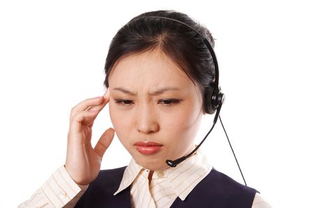 Call center operator wearing business suit standing on white with an annoyed expression.の写真素材