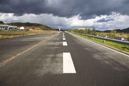  road goes into distance with a coming storm 