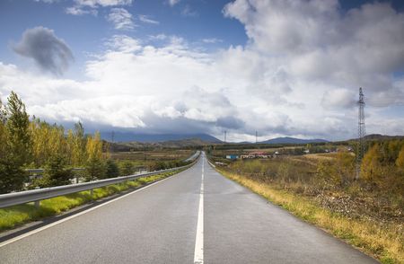 endless highway under cloudy sky の写真素材