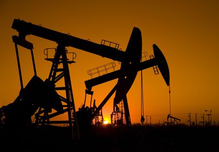 Silhouette of oil rigs with sunset の写真素材