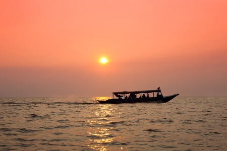 Sailing ship at sunset over the seaの写真素材