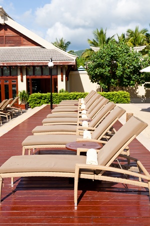 Lounge chairs at resort garden, Sanya, Hainan Island, Chinaのeditorial素材