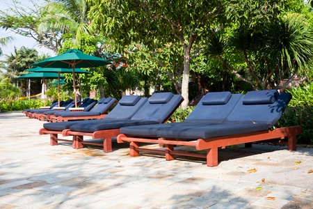 Tropical resort with chaise longue and umbrella, Sheraton Sanya Resort, Hainan Island, Chinaのeditorial素材