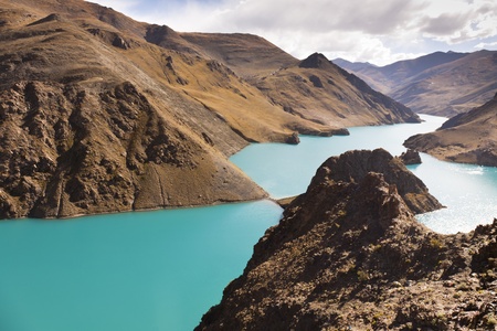 Yamdrok Yumsto Lake surrounding by snow mountains which is the most sacred lake in Tibet.の写真素材