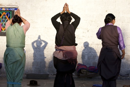 Female buddhist pilgrims are praying in front of Jokhang Temple, Lhasa, Tibet, China.のeditorial素材