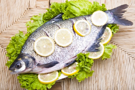 Fresh fish with lettuce and sliced lemonの写真素材