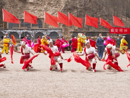 Yanan, China - April 20, 2012: People are performing Ansai Waist Drum Dance. The Ansai Waist Drum dance is a folk dance with a history of more than 2,000 years in Northern Shanxi Province of midwest China.のeditorial素材