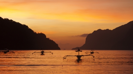 Boats moored at coastle sunsetの写真素材