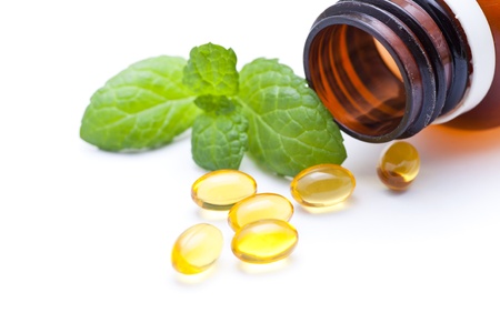Gel vitamin capsules with mint leafの写真素材