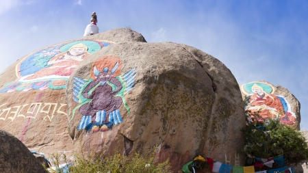 Buddha statue painted on huge stone at Drepung Monastery, Lhasa, Tibet, Drepung Monastery which was founded in 1416 and is the most superordinate among the six Tibetan gelug monasteries  Buddhist painting is royalty-free in China のeditorial素材