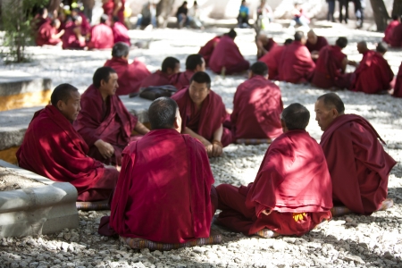 Lhasa, China - October,7, 2011: Tibetan Buddist monks are sitting cross-legged and studying Buddhism scriptures in the ritual way at Sera Monastery, Lhasa, Tibet. のeditorial素材