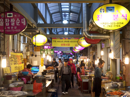 Gyeongju, South Korea - May 16, 2013: Vendors are preparing food for buyers in a local market.のeditorial素材
