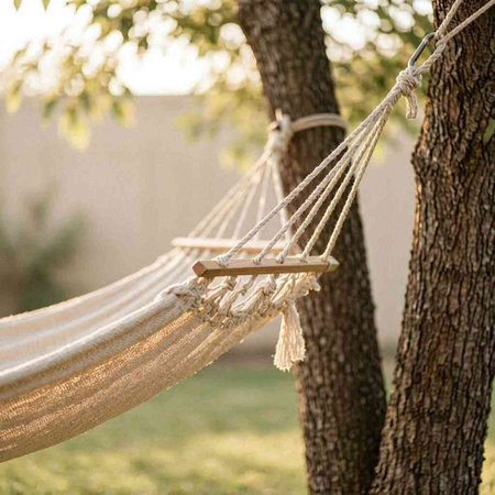 Hammock hanging on the tree in the garden. Summer concept
