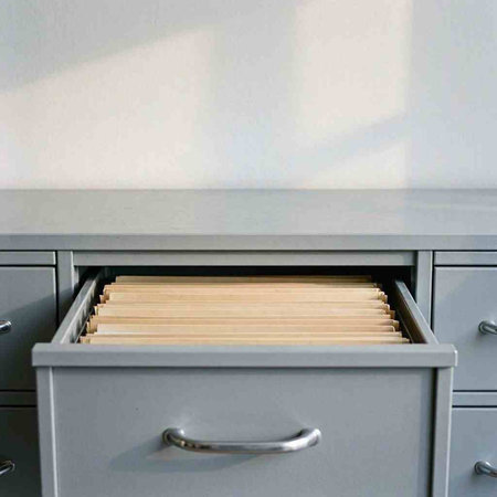 Close up of filing cabinet drawer with drawers in a modern home