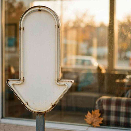 Blank white sign on the door of a cafe with autumn leaves