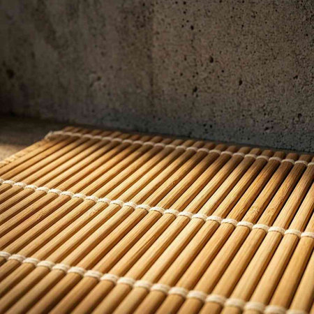 Bamboo mat on a concrete wall. Selective focus. Copy space.
