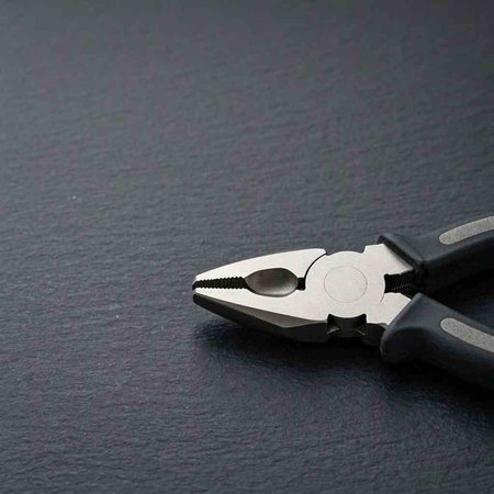 Pliers on a black background. Copy space for your text.