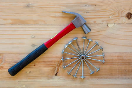 Hammer and nails with wooden background.の写真素材