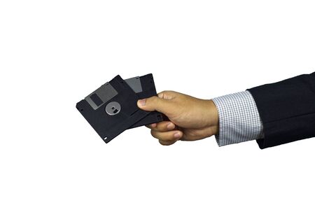 Hand of a businessman giving diskette, data leak from business partner conceptの写真素材