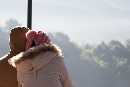 Outdoor happy couple in love posing in cold winter weather. Young boy and girl on the natureの写真素材