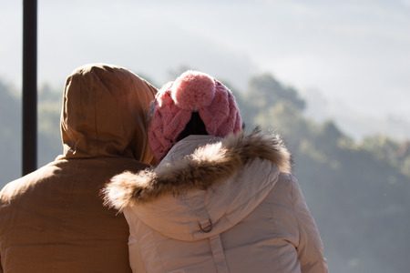 Outdoor happy couple in love posing in cold winter weather. Young boy and girl on the natureの写真素材