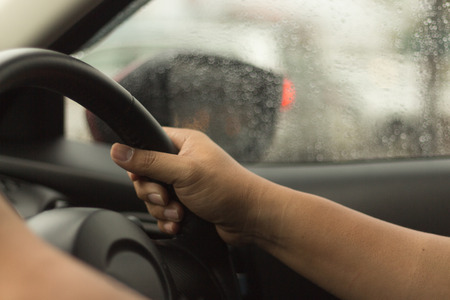Man hands grip the steering wheel driven cars.の写真素材