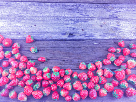 fruit. Fresh strawberries on old wooden background, with color fillerの写真素材
