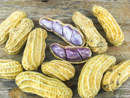 Peanut on old wooden background.