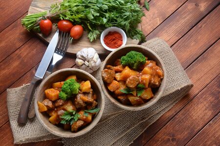 Traditional homemade Hungarian beef meat stew, Goulash with potatoes, carrots , tomatoes, broccoli in a bowlの写真素材