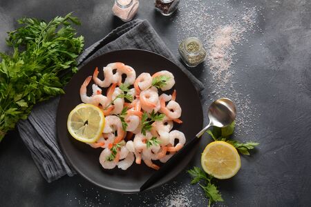 Fresh prawns. Raw shrimps, prawns in a plate on a dark background. Seafood.の写真素材