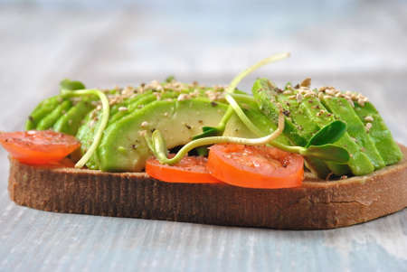 Healthy avocado sandwich , dark bread. Spicy rye toast